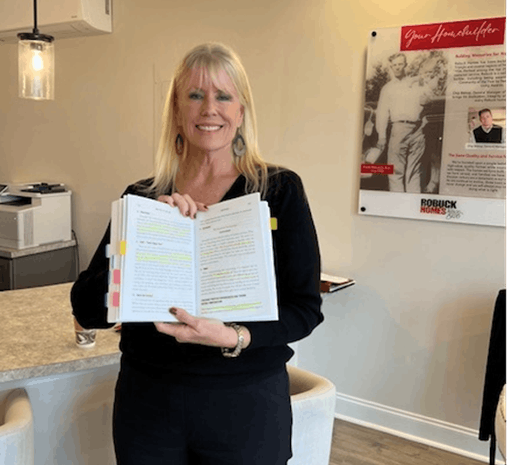 Paula Howard with her highlighted and flagged copy of Mastery of Sales for New Homes